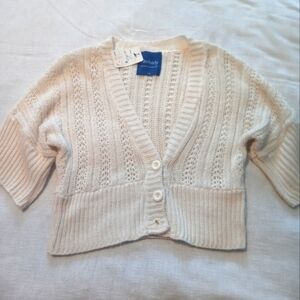 Brand new women's. Lg cream color size large short cardigan, missing last button